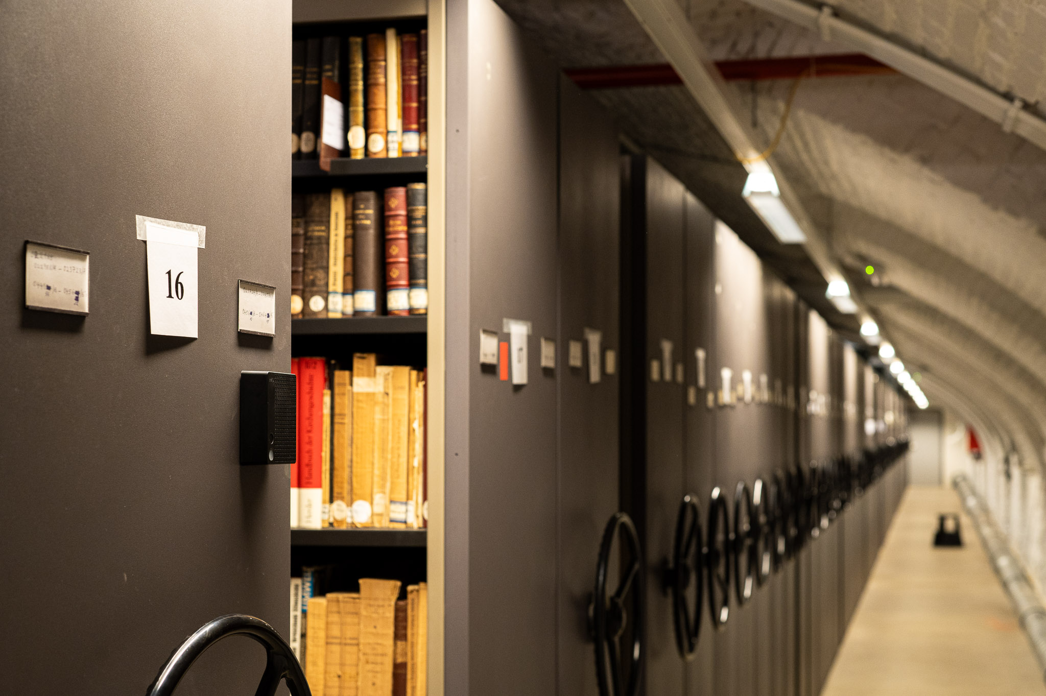 Charp loggers mounted along a long book-lined corridor in the Maurits Sabbe Library, Leuven.