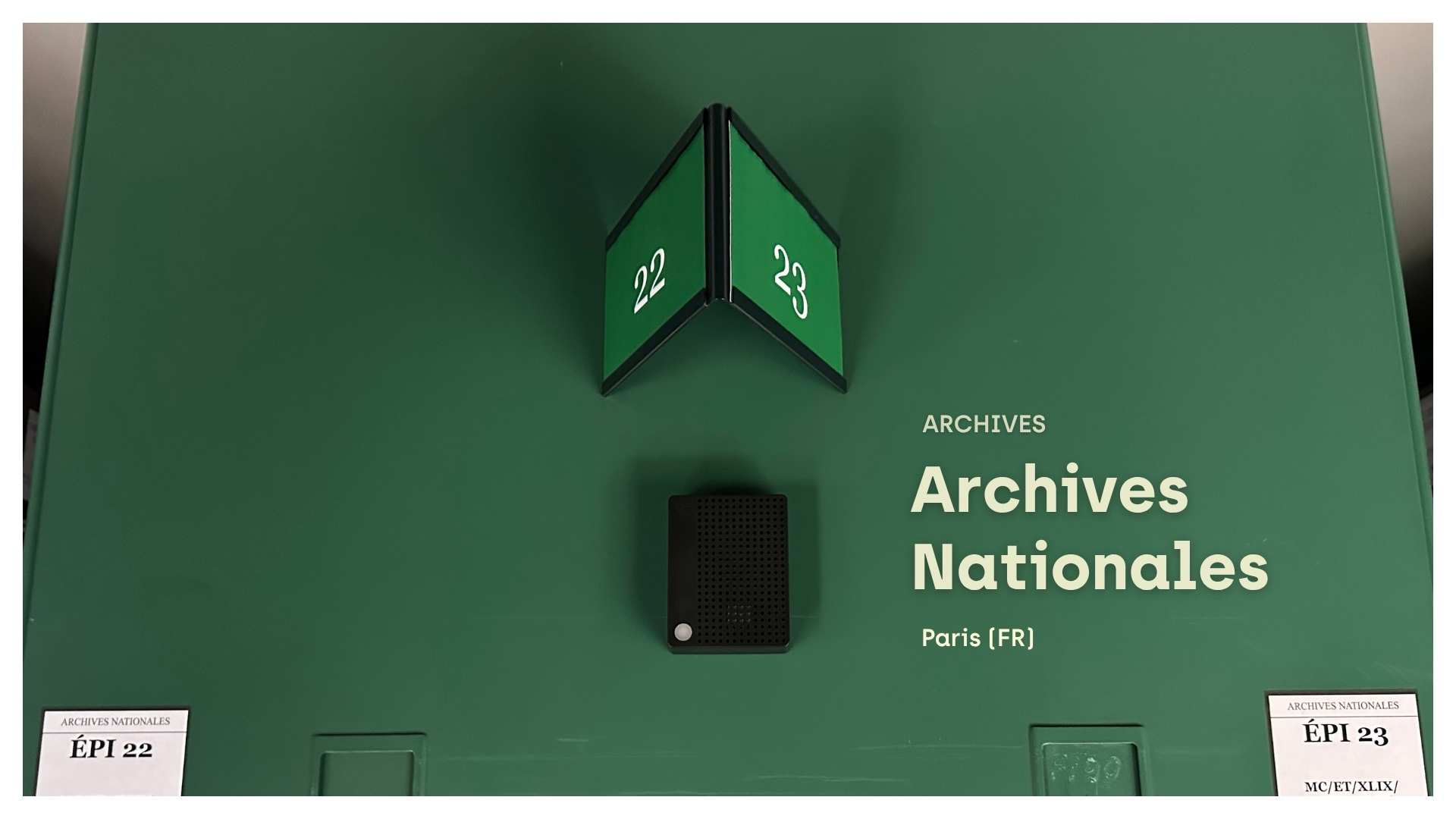 A black Charp Maxi logger mounted on a green archive cabinet at the Archives Nationales in Paris.